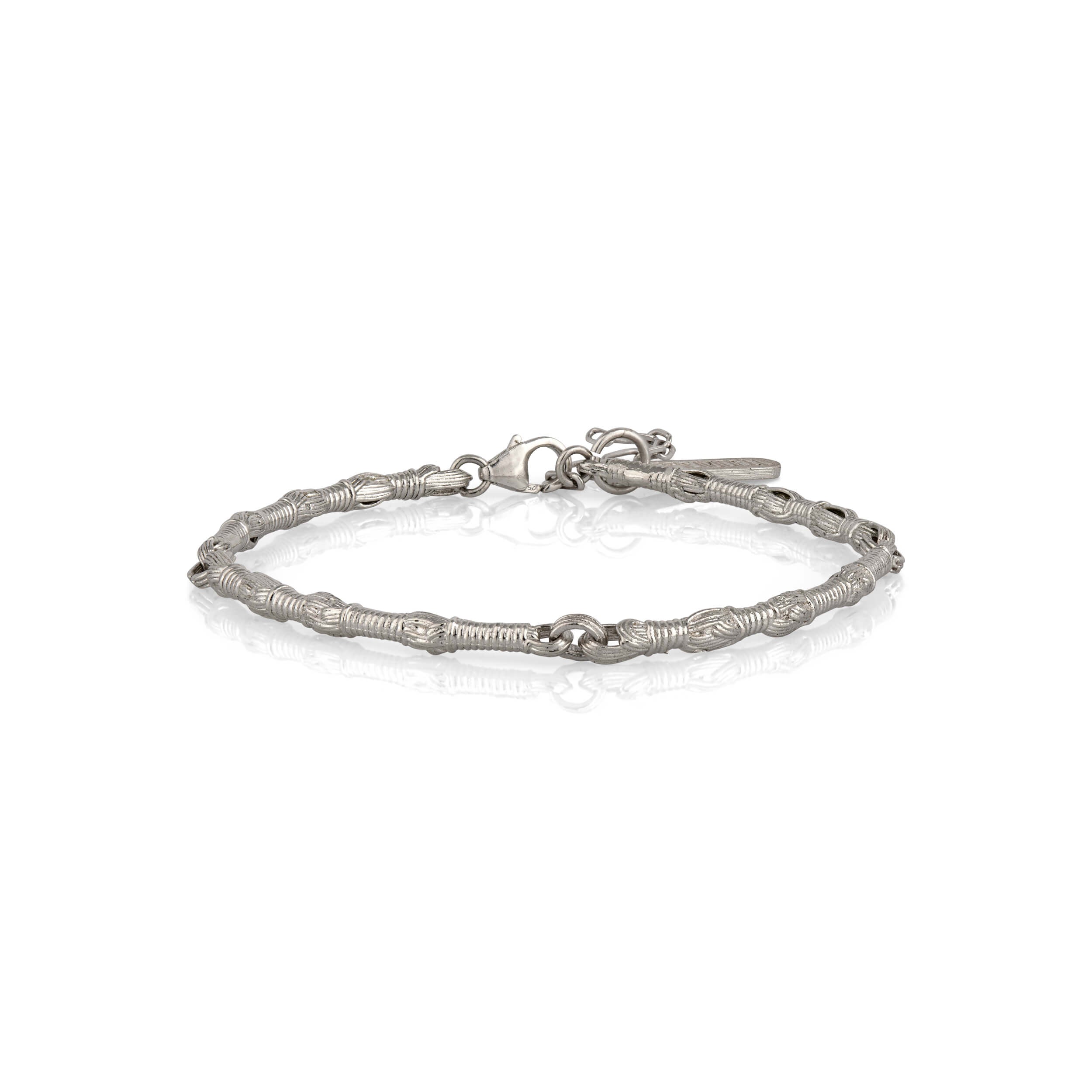 Profile view of the Breindell Tzitzit I Bracelet №1 in 925 sterling silver, showcasing the three-dimensional volume of the integrated knot. The architectural silhouette is presented on a clean white background with a soft shadow to highlight its structural depth.