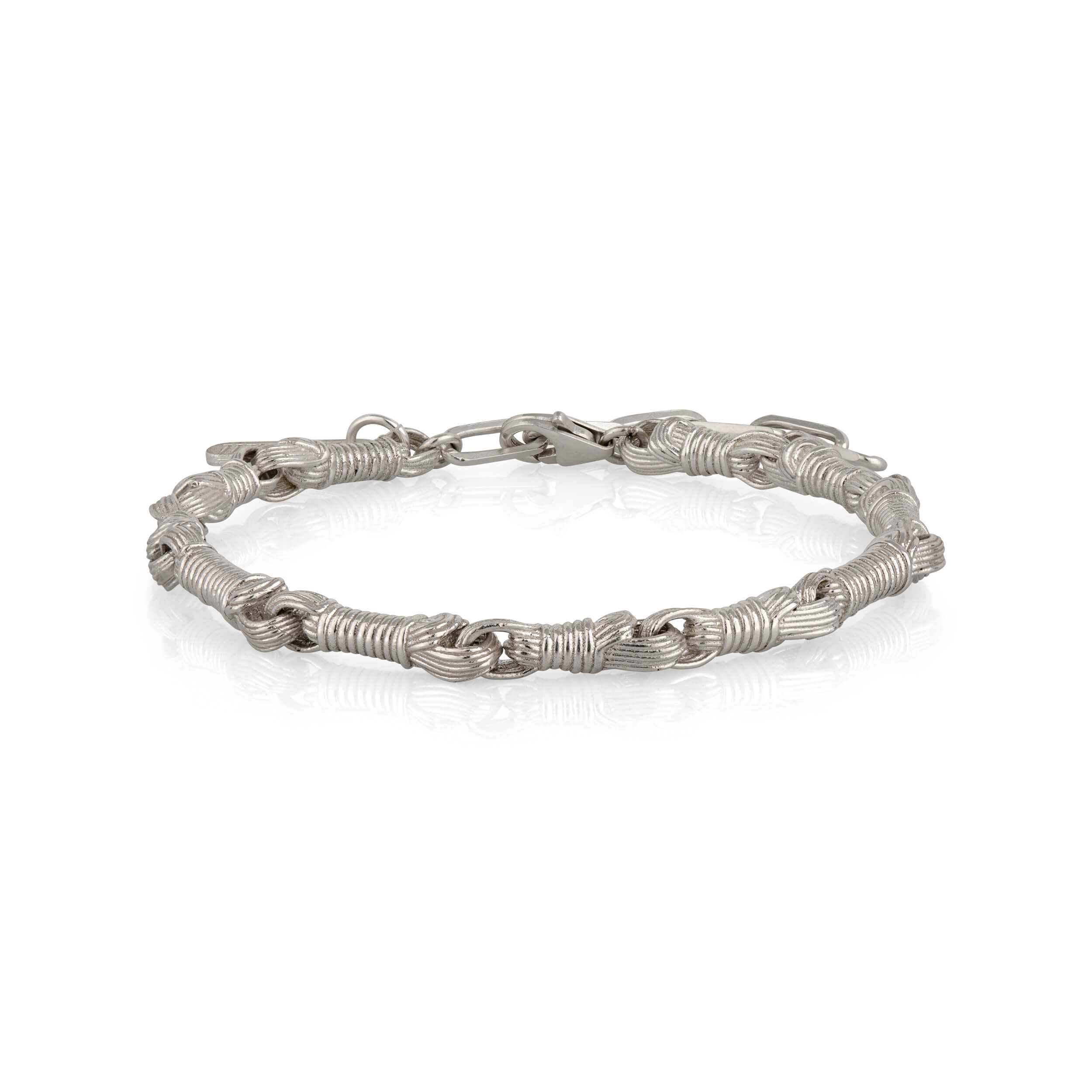 Profile view of the Breindell Tzitzit I Bracelet №2 in 925 sterling silver, highlighting the structural volume and architectural silhouette of the integrated knot. The design is presented on a minimalist white background with a soft shadow to emphasize its physical depth.
