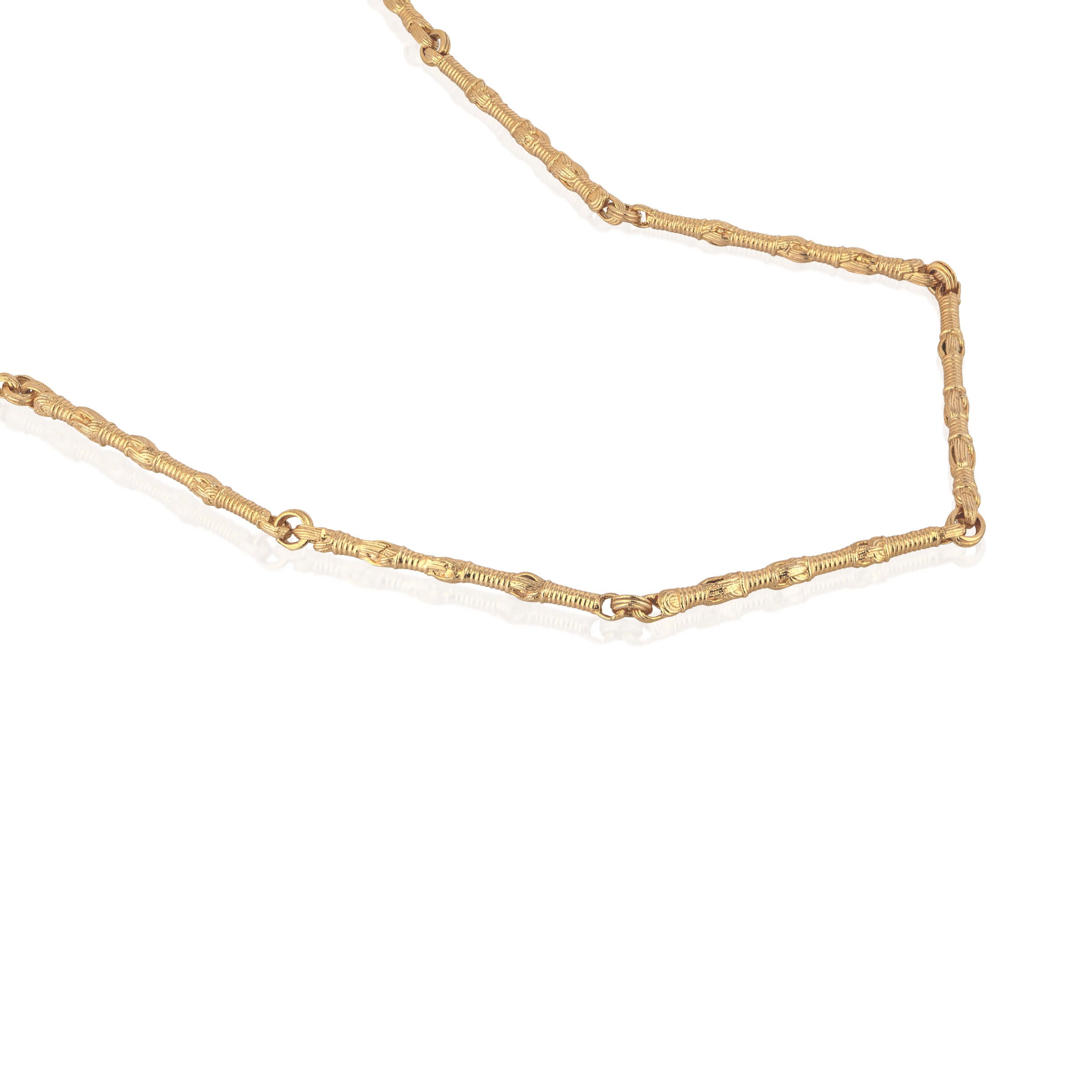 Macro detail of the Breindell Tzitzit I Necklace №1 in 14K gold. The image highlights the refined architectural geometry and polished finish of the signature integrated knot, showcasing a minimalist and structural approach to luxury design.