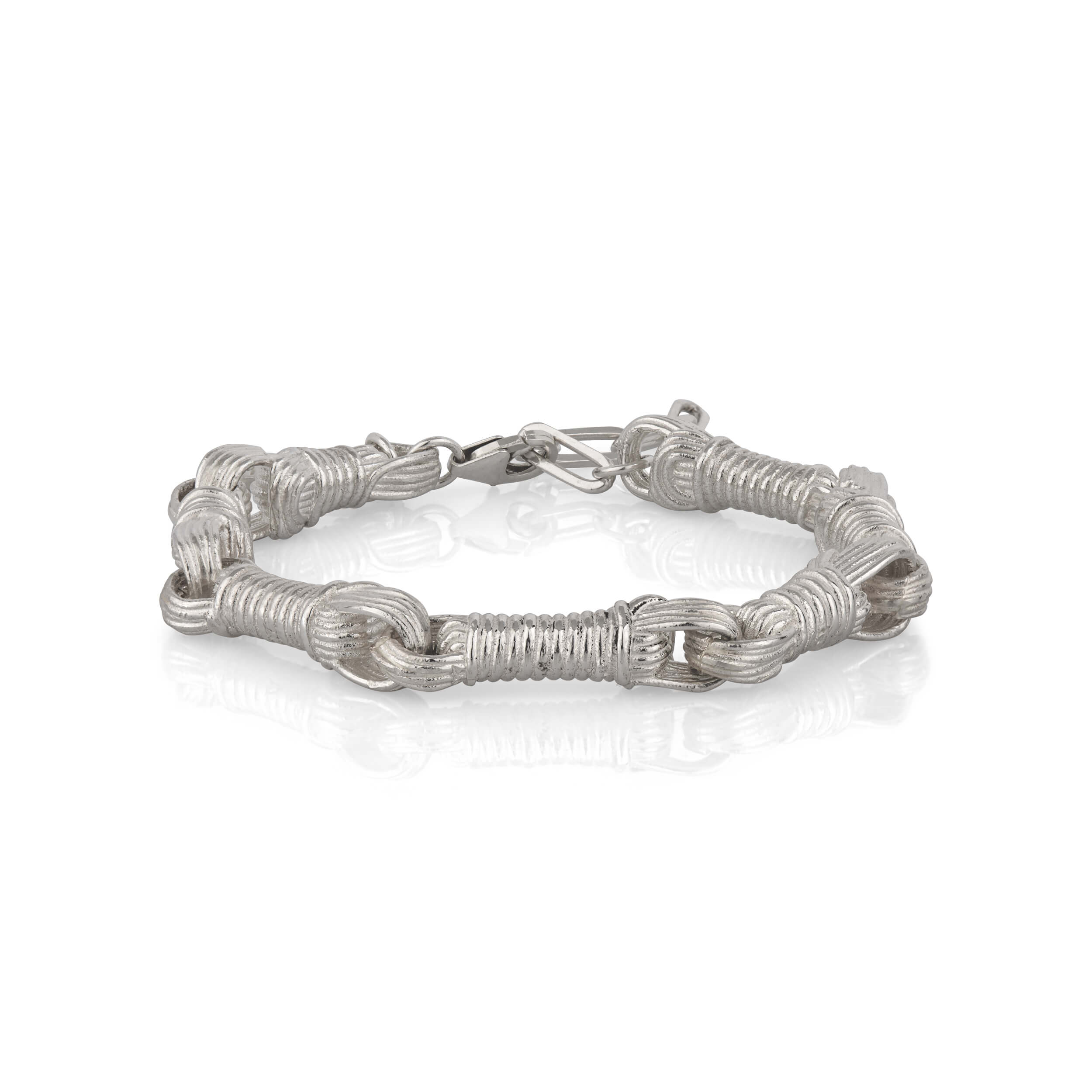 Profile view of the Breindell Tzitzit I Bracelet №3 in 925 sterling silver, showcasing the three-dimensional volume and architectural silhouette of the signature integrated knot. The design is presented on a minimalist white background with a soft shadow to highlight its structural depth.